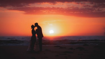 silhouette-couple-bride-groom-holding-hands-during-sunrise-time-beach_44161-86